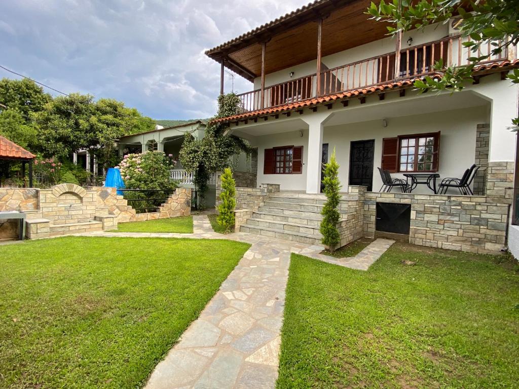 a house with a patio and a grass yard at Casa Lanardi, Stavros in Stavros