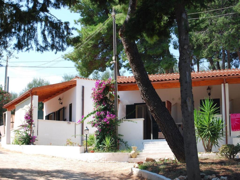 a house with flowers in front of it at Althea Village Residence in Vieste