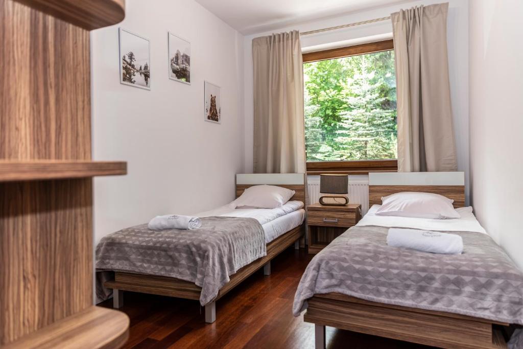 Posteľ alebo postele v izbe v ubytovaní TatryTOP Apartamenty Kaszelewski