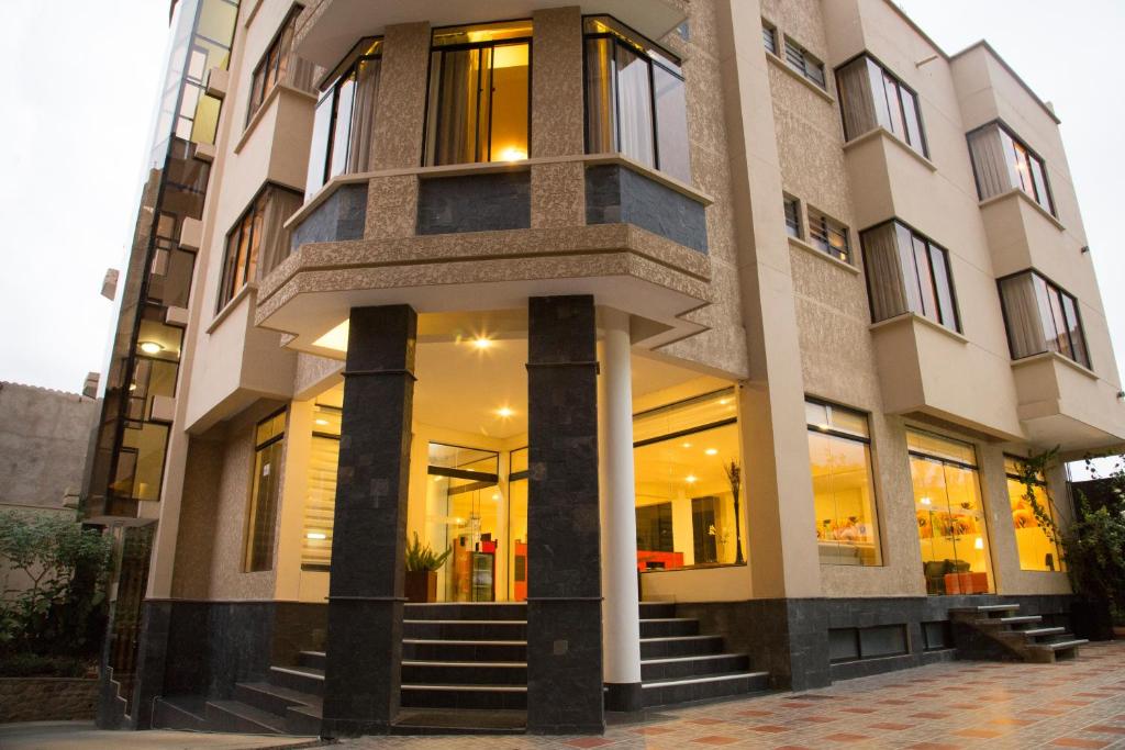 a building with windows and stairs in front of it at Hotel Granny in Tarija