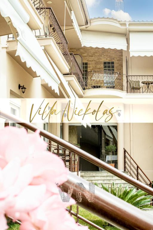 a building with a sign that reads villa vibes at Villa Nickolas in Paleo Tsifliki