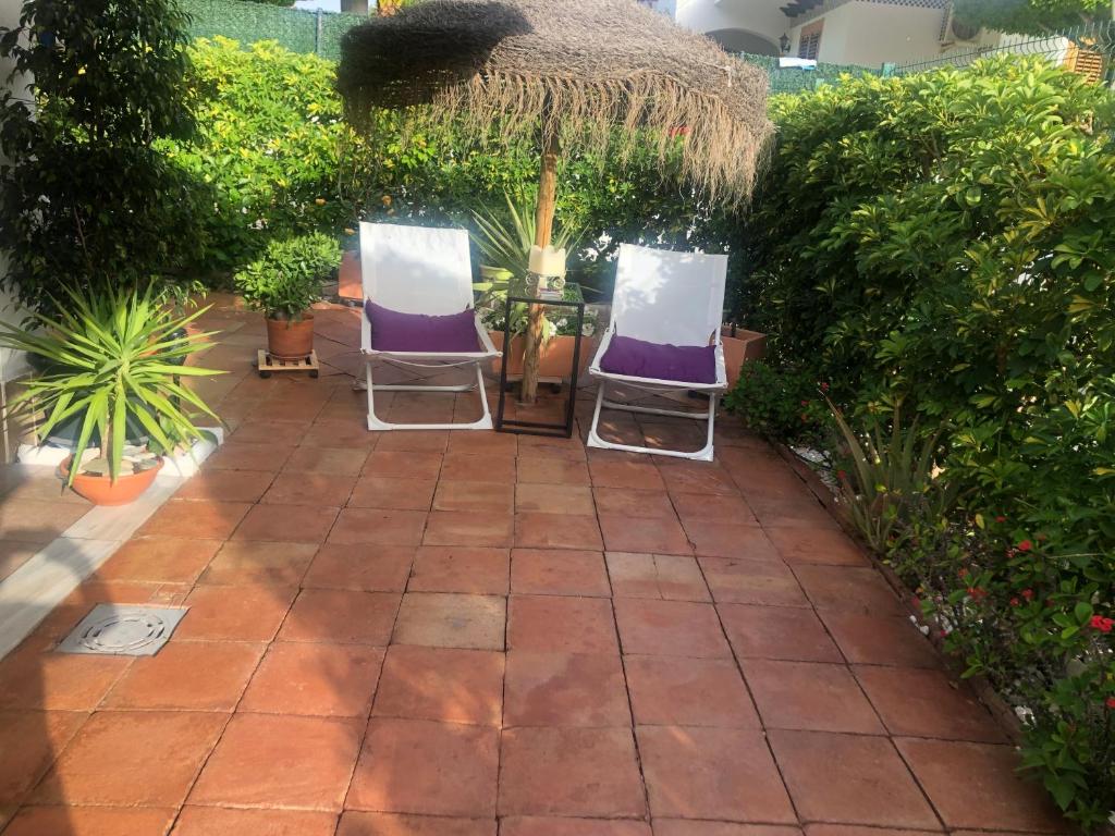 ベラにあるDuplex Vera - Playaの庭園内の椅子2脚とテーブル