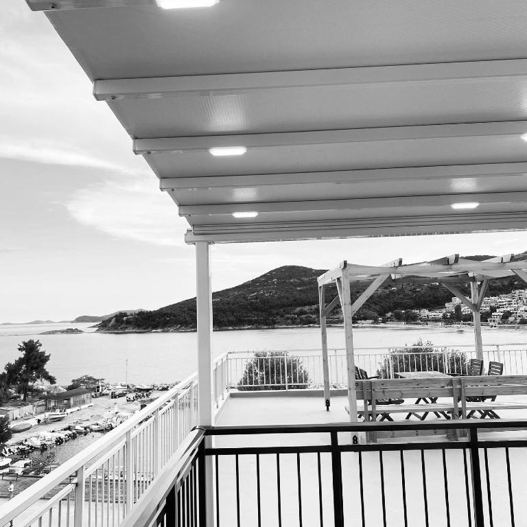a porch with chairs and a view of the ocean at Overwave Apartment in Kavála