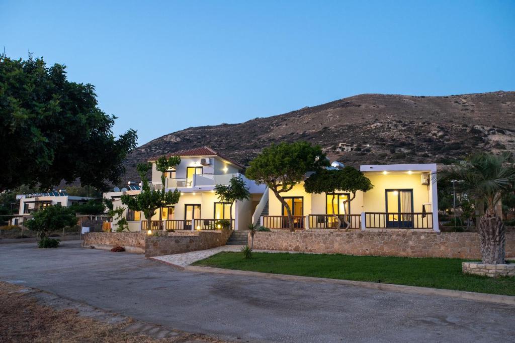 a house with a mountain in the background at Adam in Falasarna