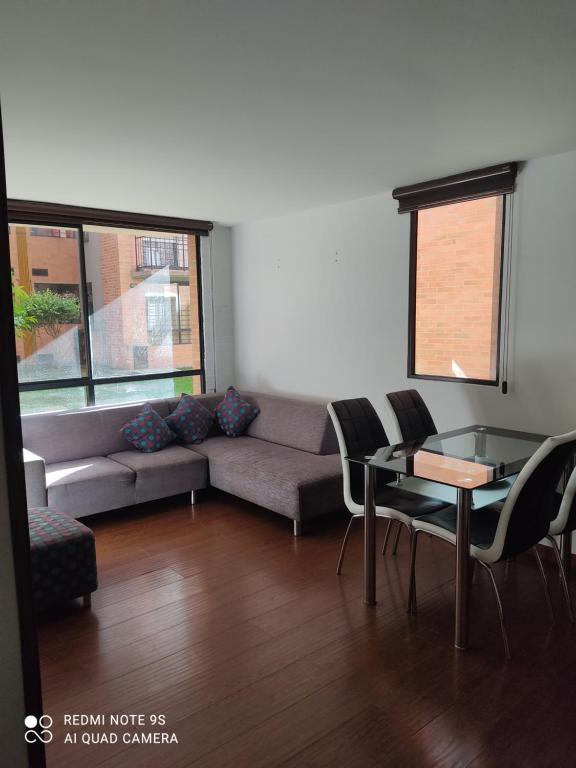 a living room with a couch and a table and chairs at Apartamento en Mosquera in Mosquera