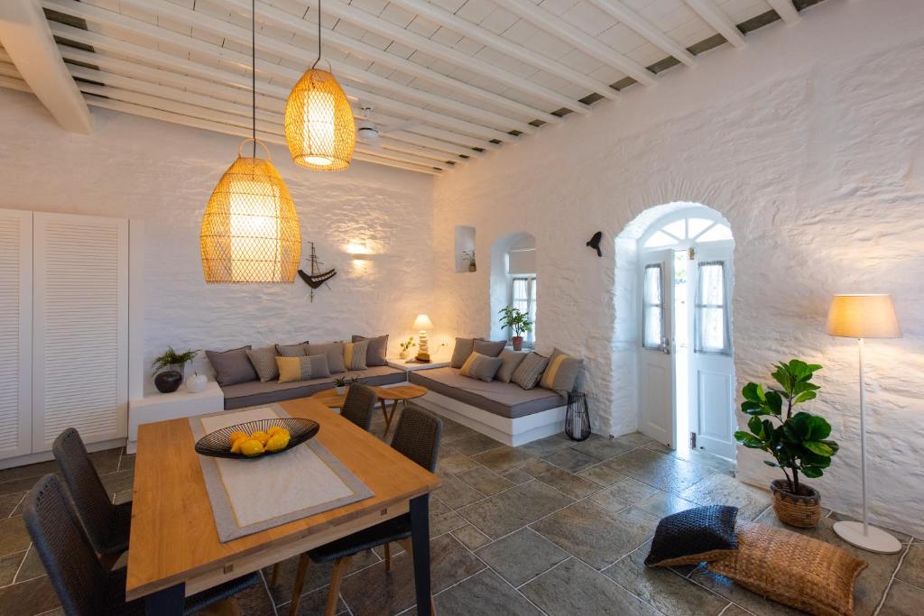 a living room with a table and a couch at NIREAS STONEHOUSE IN APOLLONIA SIFNOS in Sifnos