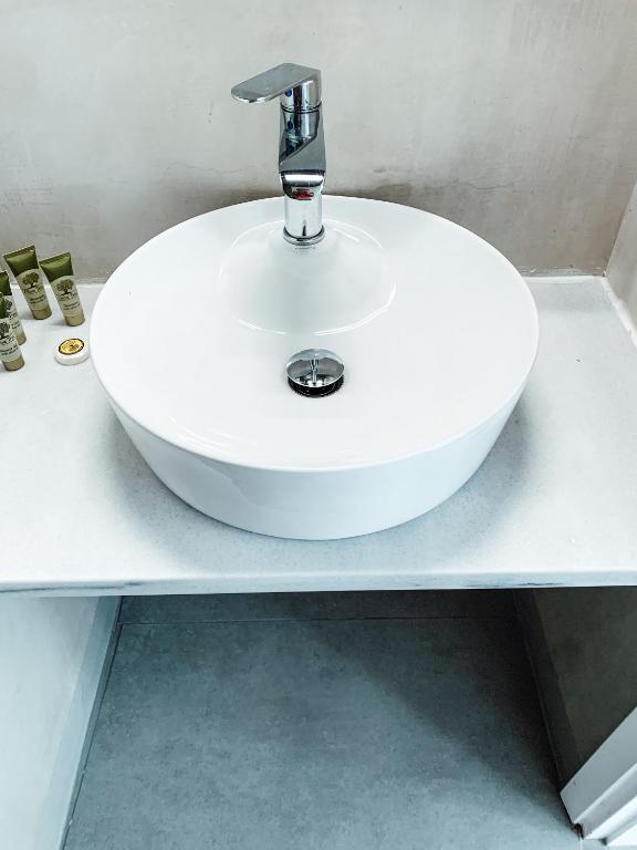 a white sink on a counter in a bathroom at Fabrica Sunset Apartments in Megali Ammos