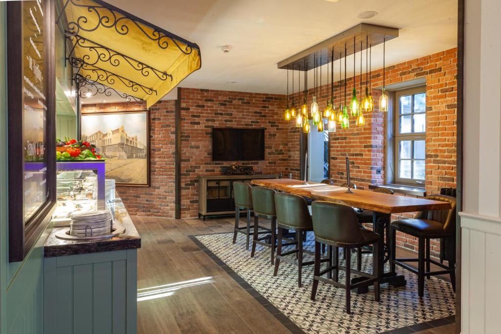 a kitchen with a brick wall and a table and chairs at Europa Hotel Kühlungsborn in Kühlungsborn