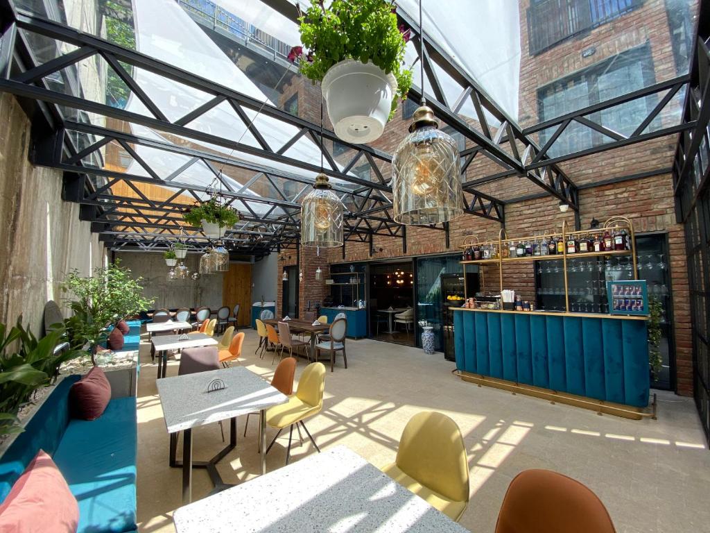 a restaurant with tables and chairs and a bar at About Sololaki in Tbilisi City
