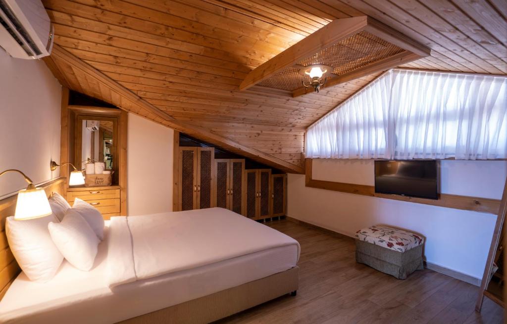 Postel nebo postele na pokoji v ubytování XOX Apart Hotel