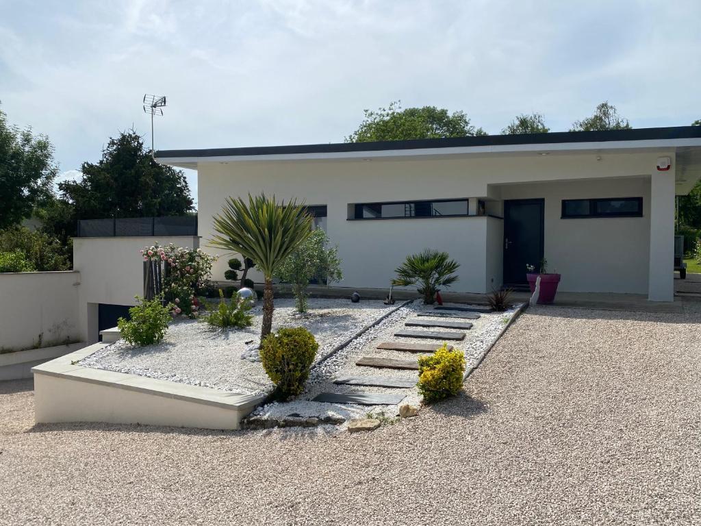 a house with a gravel yard in front of it at Chez Sophie in Dole