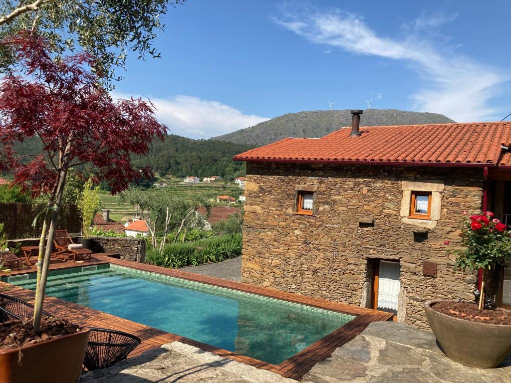 a house with a swimming pool next to a building at Casa Lia da Pôrta in Caminha