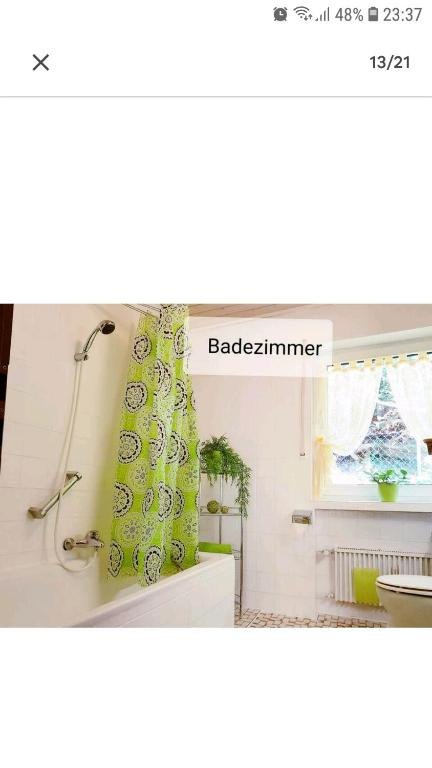 a bathroom with a shower curtain and a window at 4 Erw. 1 Ki. Ski Entspannung Terasse Ausblick in Schmallenberg