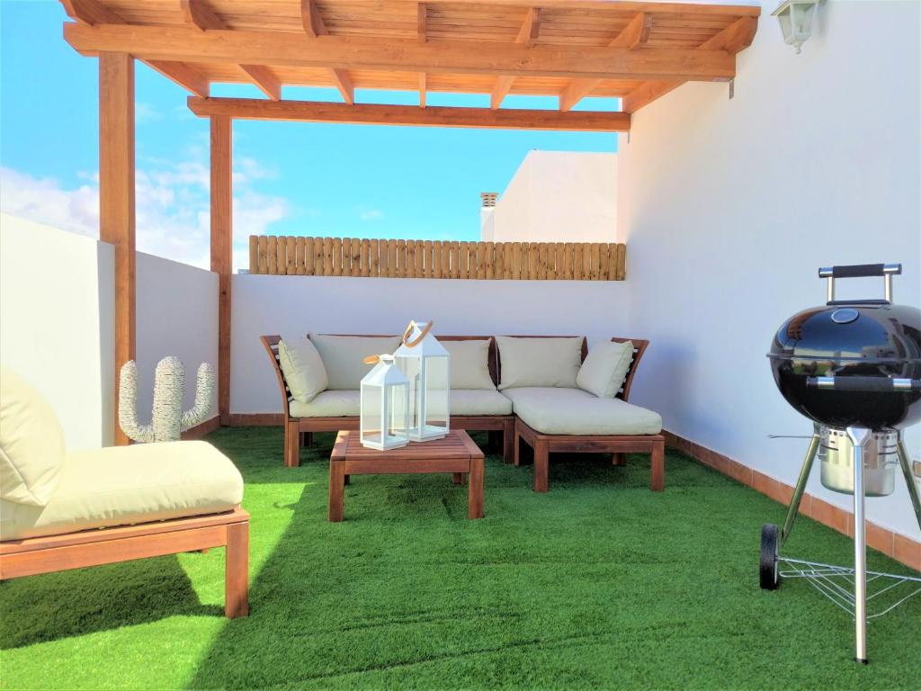 a living room with two chairs and a table and aopter at Silver Ocean Puerto Lajas by Sea You There Fuerteventura in Puerto de las Lajas