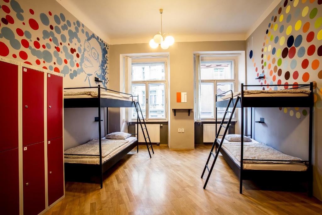 a room with three bunk beds in it at Ahoy! Hostel in Prague