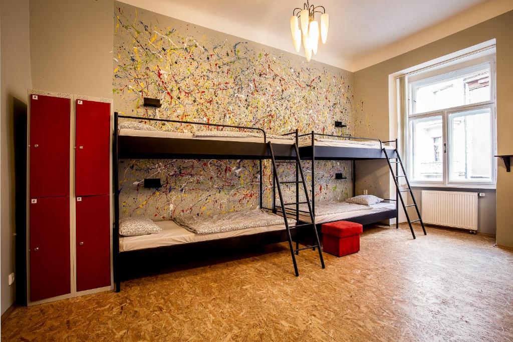 two bunk beds in a room with a wall at Ahoy! Hostel in Prague
