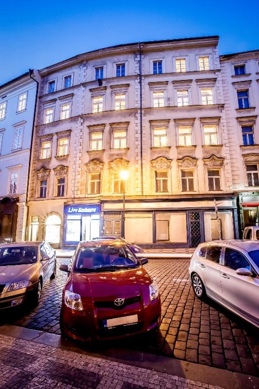 a red car parked in front of a building at Ahoy! Hostel in Prague