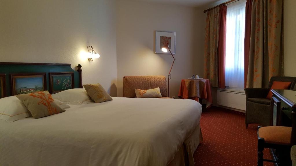Postel nebo postele na pokoji v ubytování Hôtel Winzenberg