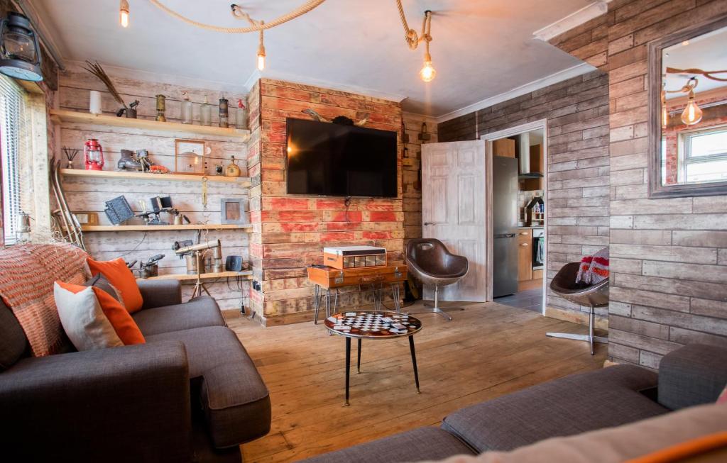 a living room with a brick wall at James’ Place @ Bike Park Wales and The Brecon Beacons in Merthyr Tydfil