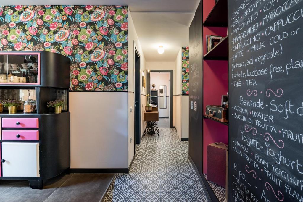 a corridor of a restaurant with a chalkboard wall at Contus Rétro Guest House in Cagliari