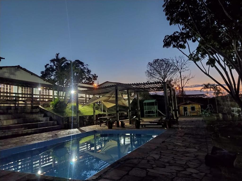 a swimming pool in front of a building at Vereda Bike Park Hotel in São João del Rei