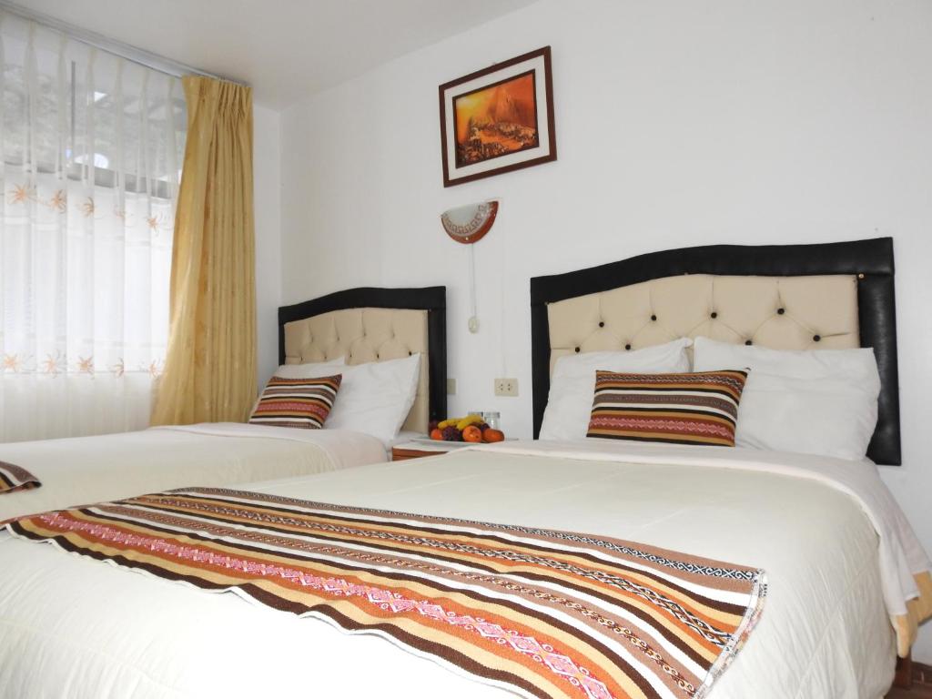 Postel nebo postele na pokoji v ubytování Hostal Encanto Machupicchu