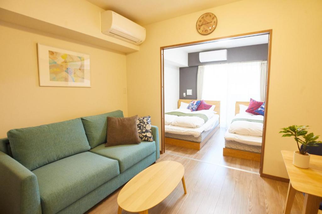 uma sala de estar com um sofá e um quarto em SG Premium KASAI - Vacation STAY 44284v em Tóquio
