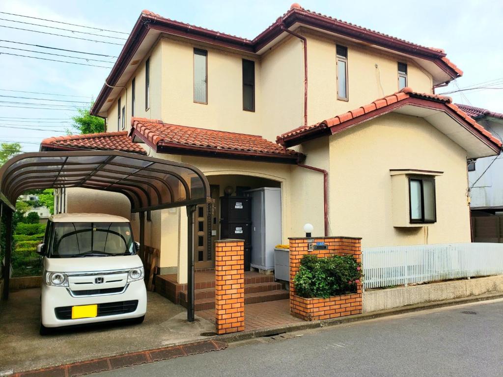 a white car parked in front of a house at Within walking distance of Disneyland! - Vacation STAY 11473 in Urayasu