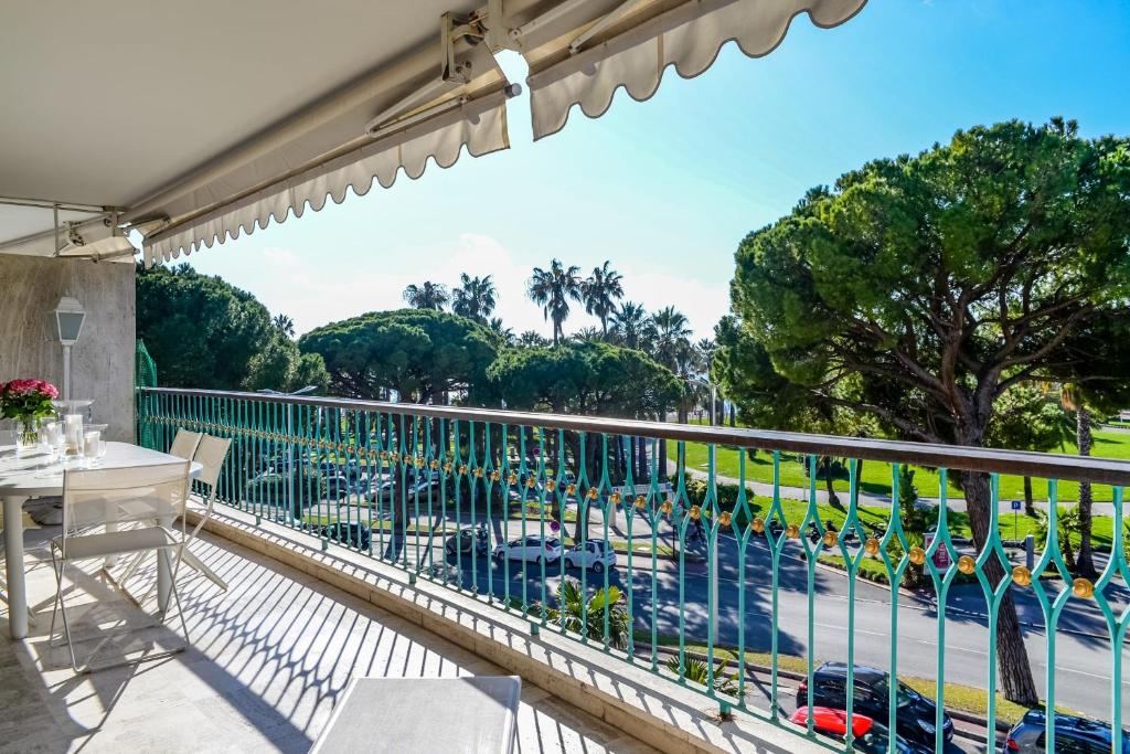 a balcony with a view of a pool and trees at IMMOGROOm- two terraces - Sea view - CROISETTE - AC in Cannes