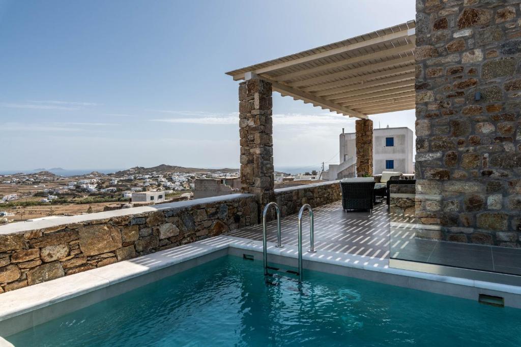a swimming pool in a villa with a view at DeKo Villa Mykonos in Ano Mera