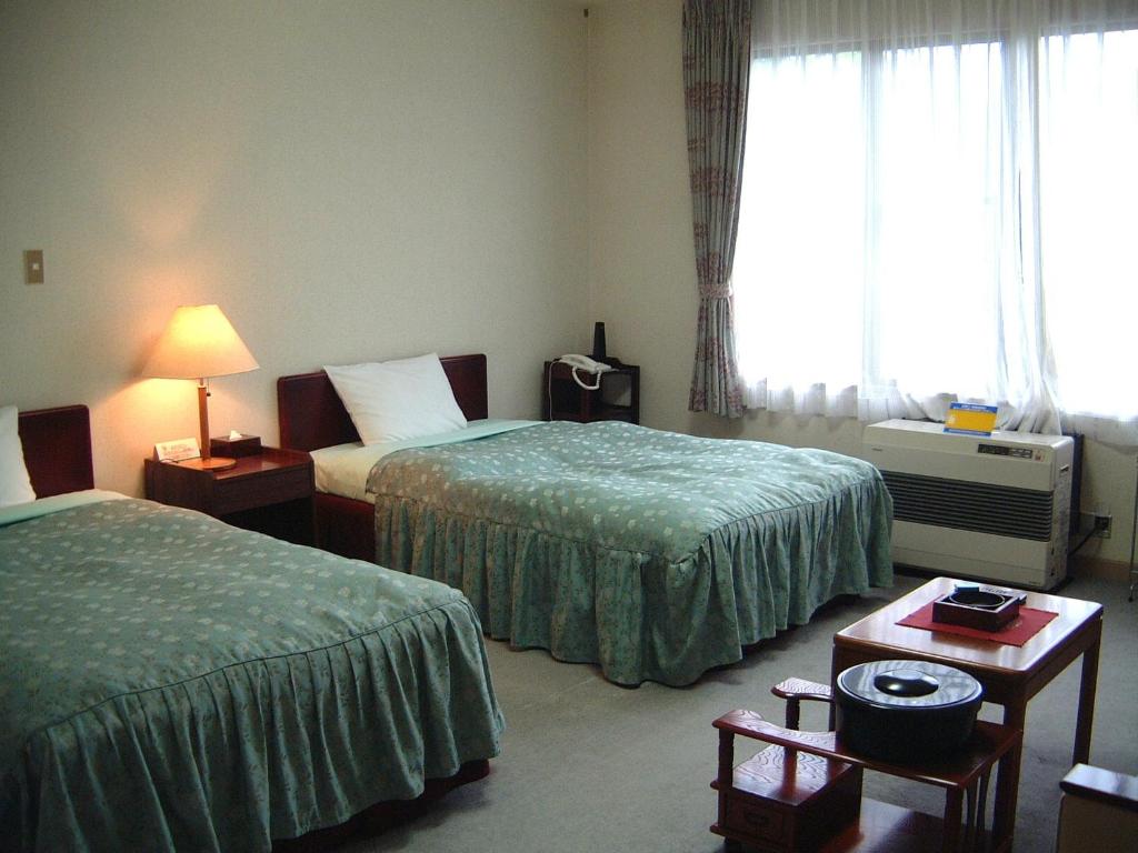 Ein Bett oder Betten in einem Zimmer der Unterkunft Towadako Lakeside Hotel