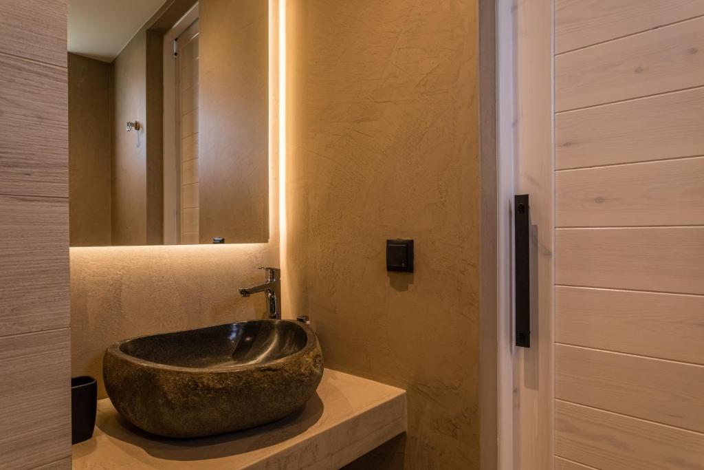 a bathroom with a large bowl sink on a counter at Lighthouse Apartments in Stoupa