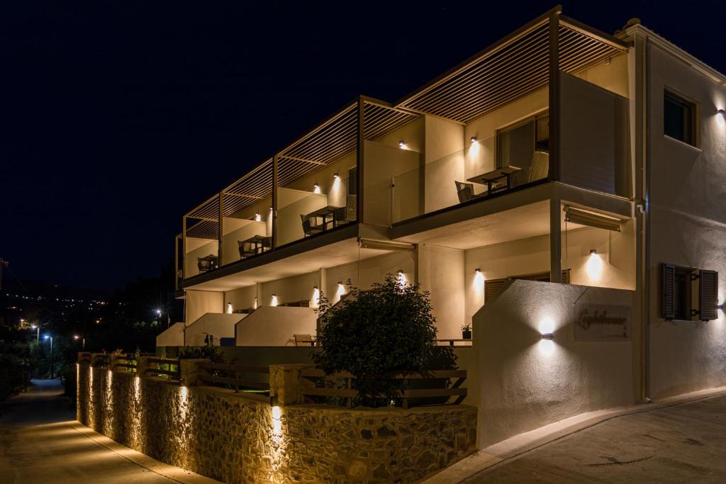 a building with lights on the side of it at night at Lighthouse Apartments in Stoupa