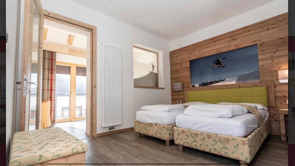 Postel nebo postele na pokoji v ubytování Hotel Eccher 3 stelle Superior