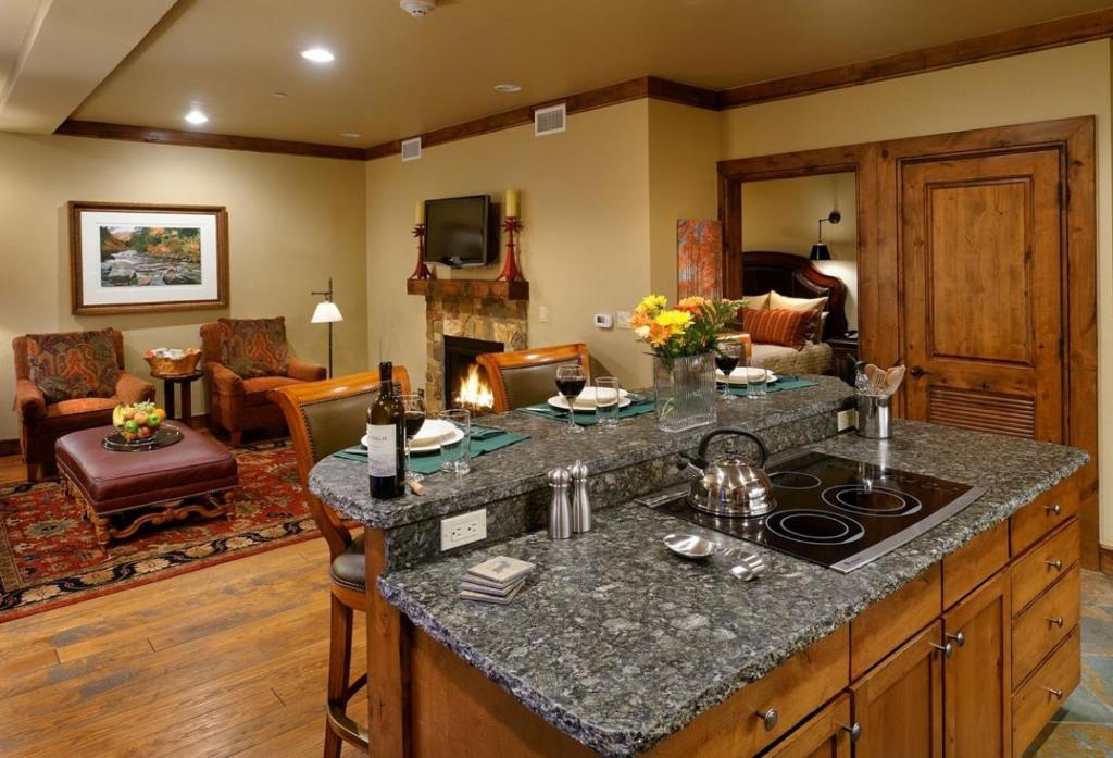 a kitchen with a counter top and a living room at Innsbruck Aspen Deluxe One-Bedroom Garden Residence 1, Located on Main Street in Aspen