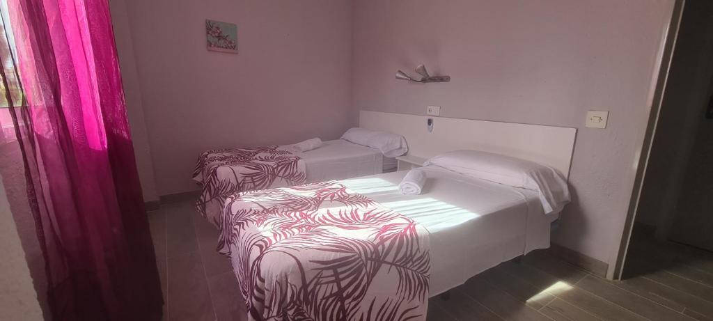 Postel nebo postele na pokoji v ubytování Hostal La Cabaña