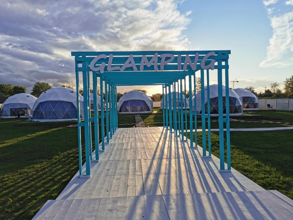 a blue archway with tents in a field at Glamping By The Sea in Năvodari