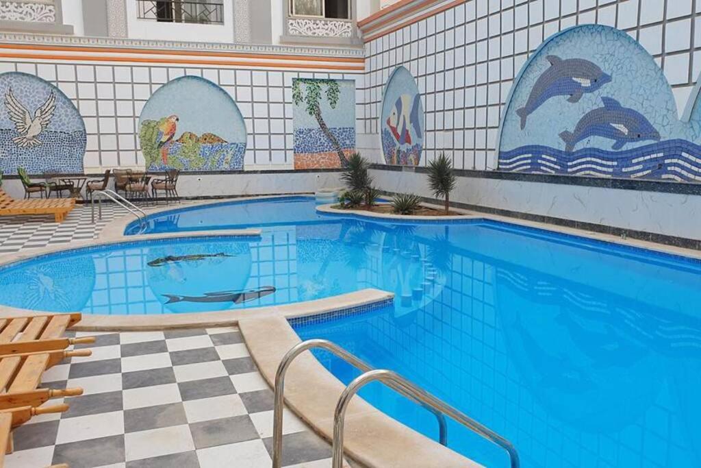 a large swimming pool with a tile wall at 201Sheraton Plaza in Hurghada