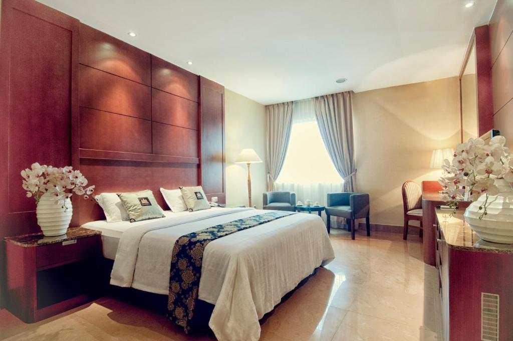 Postel nebo postele na pokoji v ubytování Grand Sakura Hotel