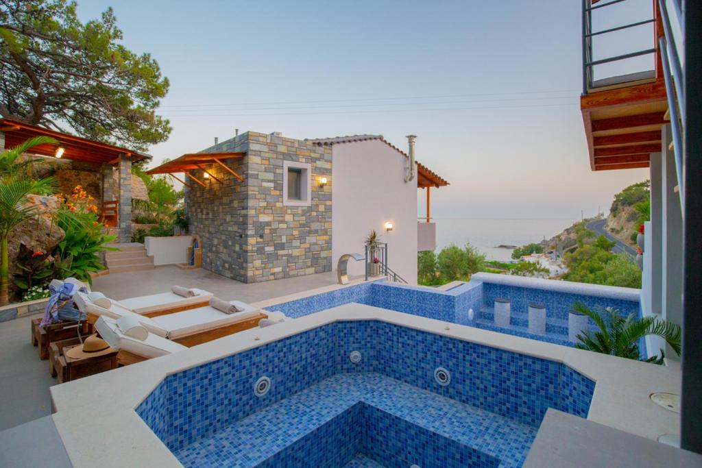 a villa with a swimming pool and a house at Villa Achlia in Achlia
