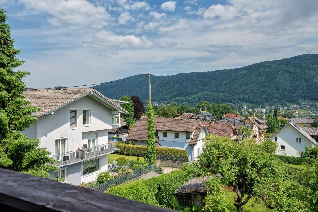a group of houses in a village with mountains at Haus unter Gerlitzen in Bodensdorf