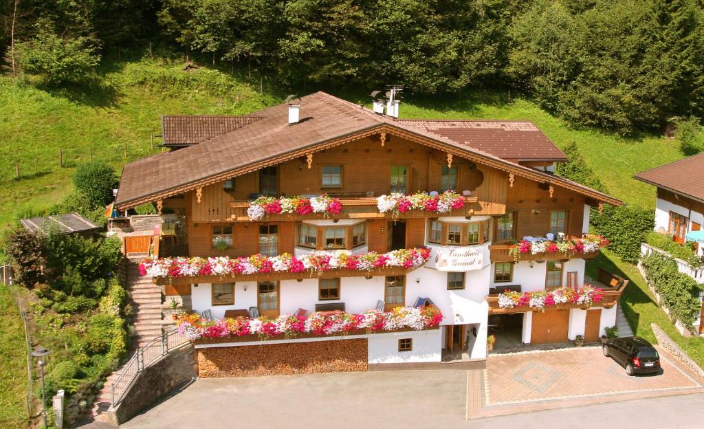 a house with flowers on the side of it at Landhaus Granat in Mayrhofen
