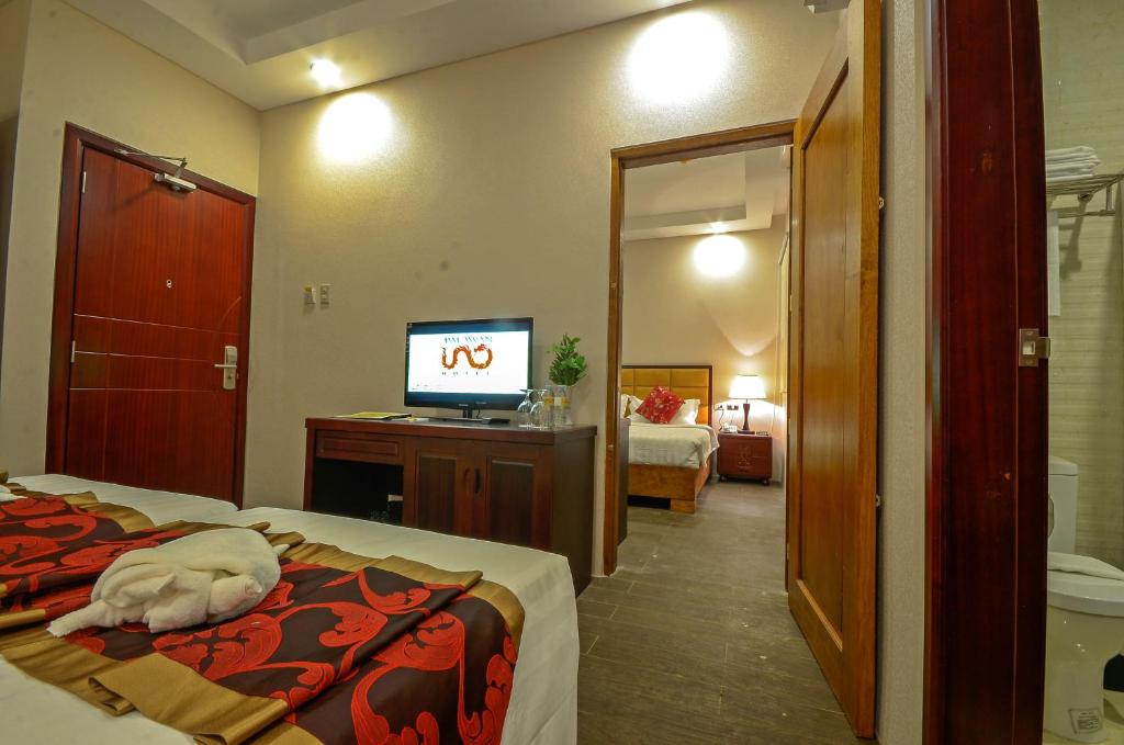 Postel nebo postele na pokoji v ubytování Palawan Uno Hotel
