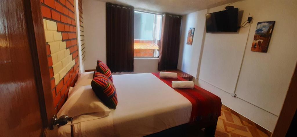 Postel nebo postele na pokoji v ubytování Quipu Hostal