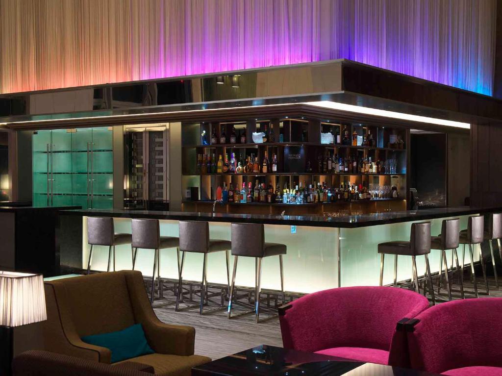 a bar in a room with purple lights at Osaka Marriott Miyako Hotel in Osaka