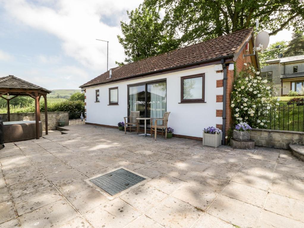 a cottage with a patio and a gazebo at The Stables in Taunton