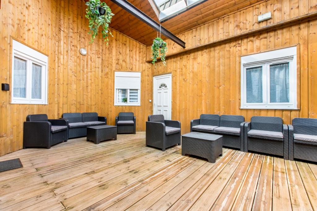 a room with couches and chairs on a wooden floor at STAR WARS in Tourcoing