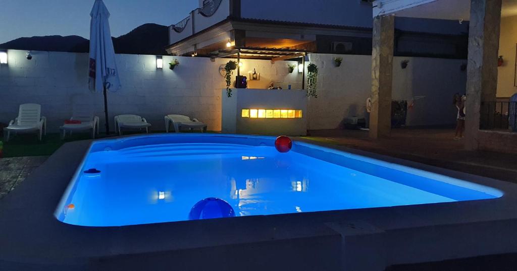 a swimming pool in a backyard at night at Alojamiento Rural el Respiro "Calma" in Benaocaz