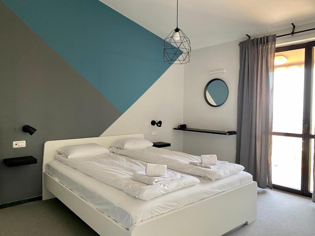 a bedroom with a white bed with a blue ceiling at Villa Darina in Portorož