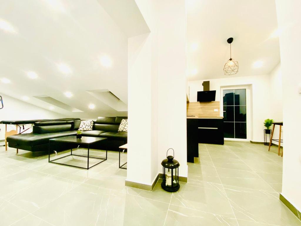 a living room with a couch and a table at Apartma Teja-Dekani in Dekani